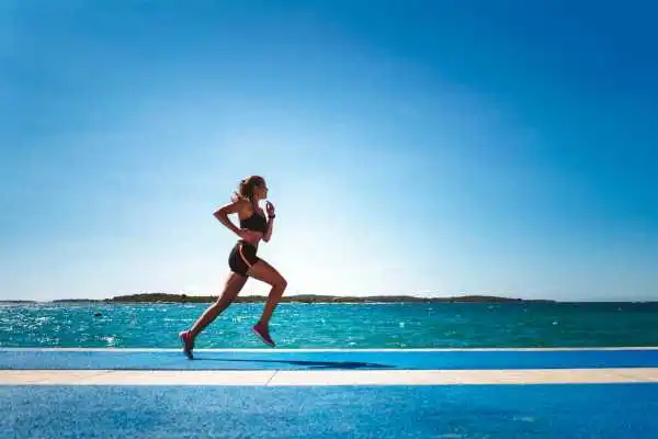 Woman running showing strong leg muscle Tamworth